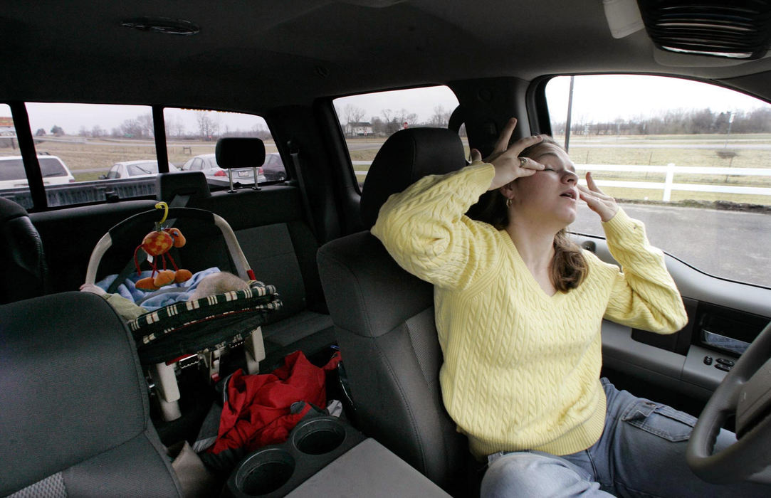 Third Place, Feature Picture Story - Chris Russell / The Columbus DispatchGabriel sleeps in a car seat in the back while Lee Ann rubs her tired eyes after dropping the older boys off at school.  