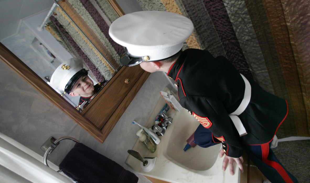 Third Place, Feature Picture Story - Chris Russell / The Columbus DispatchAfter begging his mother to show off his uniform, Harrison Ivy, 5, checks himself out in his replica "Marine Dress Blues" that Lee Ann bought before her husband was killed in Iraq.  She had hoped to photograph the kids in uniform with their father.