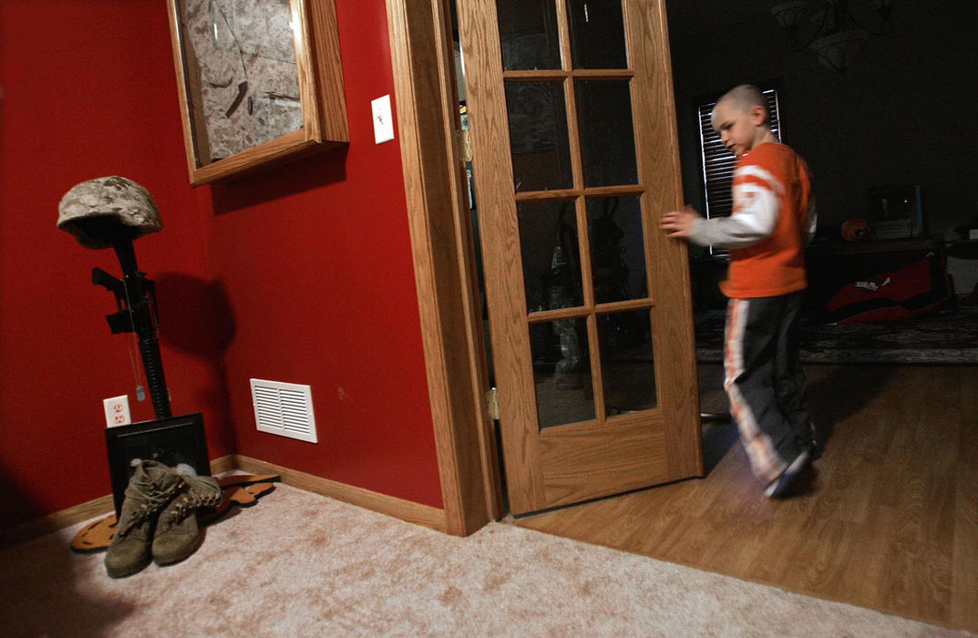 Third Place, Feature Picture Story - Chris Russell / The Columbus DispatchHarrison Ivy looks behind at the special room dedicated to his father's memory in their new home in Mansfield.  He was getting ready to head for  school.   