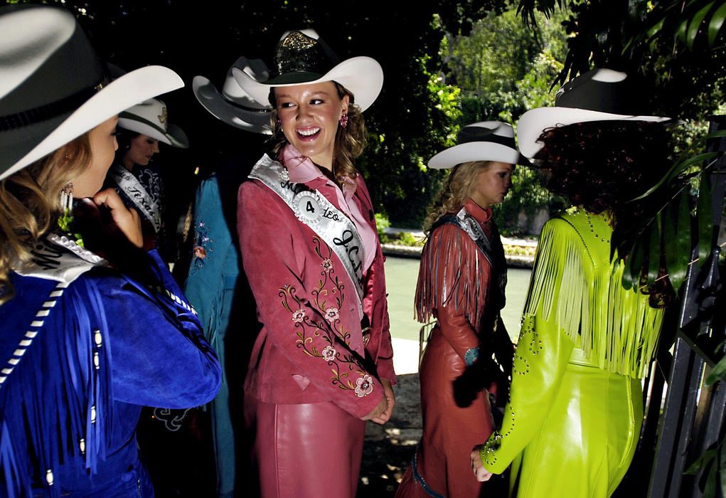 Award of Excellence, Feature Picture Story - Greg Ruffing / FreelanceThe Miss Rodeo Texas Pageant began in 1963 to promote Texas pride, Western heritage and the professional sport of rodeo. Miss Rodeo Johnson County Sheriff Posse Teen, Whitney Cooper (center, in pink) of Joshua, Texas, socializes with other contestants during the Miss Rodeo Texas Pageant as they take a tour of the historic Riverwalk in downtown San Antonio.