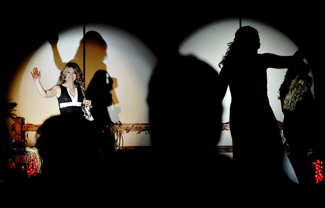 Award of Excellence, Feature Picture Story - Greg Ruffing / FreelanceMiss Rodeo Shelby County, Joanna Blackwell (left) of Center, Texas, and other contestants parade before the judges (silhouetted in foreground) while modeling evening wear. The fashion show marked the end of a week of contests--next it was time for the girls to prepare for the final Coronation the following night.