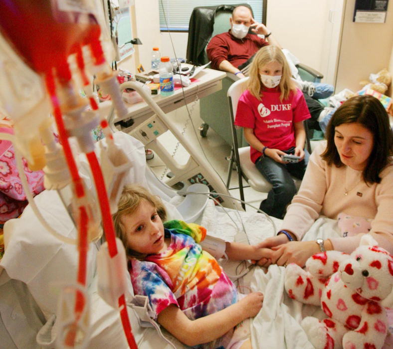 First Place, Feature Picture Story - John Kuntz / The Plain DealerDakota lies on her hospital bed January 27, 2006 as she receives her cord blood transplant from the rich stem cell blood from the umbilical cord of a recent birth as her family watches. 