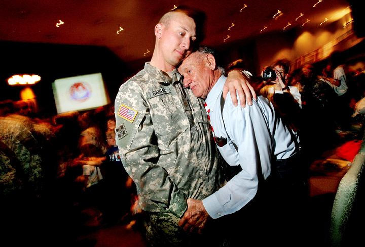 First Place, General News - Eric Albrecht / The Columbus DispatchMitch Gargac gives his father Ray an embrace in the sanctuary  of the Vineyard Church. Mitch and fellow soldiers were marching out after dismissal ceremony that included videos and speeches welcoming them home when Mitch spotted his father.