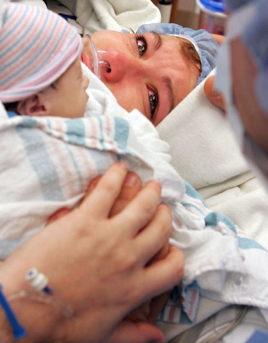 Award of Excellence, General News - Ron Alvey / Dayton Daily NewsJennifer and Frank South hold hands and their newborn son, James, just minutes after Jennifer gave birth. Early in the pregnancy, James was diagnosed with Limb Body Wall Complex and was not expected to live. James lived for approximately four hours, giving the parents and family members time to fellowship and coo over James.