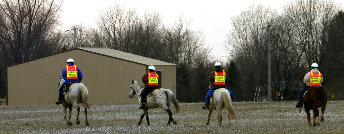 Second Place, News Picture Story - Marsahll Gorby / Springfield News-SunSearch and rescue volunteers on horseback search a field near Greenon High School for two and a half year old Cayden Workman. 