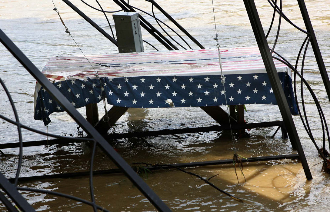 Third Place, News Picture Story - Thomas Ondrey / The Plain DealerA picnic table ready for a summertime weekend stands in a riverside  shelter twisted by the floodwaters of the Grand River in Fairport Harbor.   