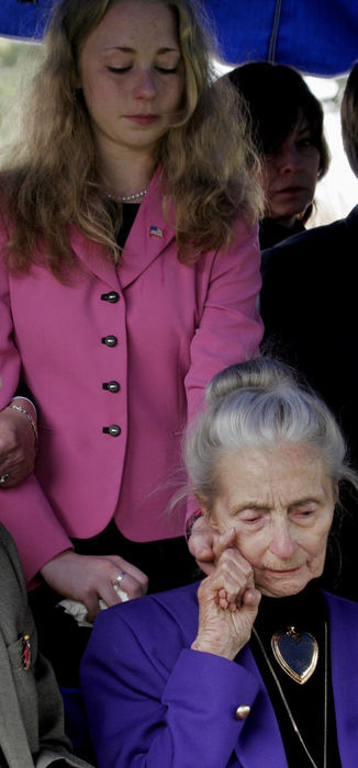 Award of Excellence, News Picture Story - Tim Revell / The Columbus DispatchBrittanny Lee, 17, holds the hand of her grandmother Mary Alice Foster  during the grave side ceremony of 2nd Lt. Charles "Buddy " Feucht  at Glen Rest Memorial Cemetery.  Feucht was missing in action since 1943. Mary Alice is the sister of Buddy. 