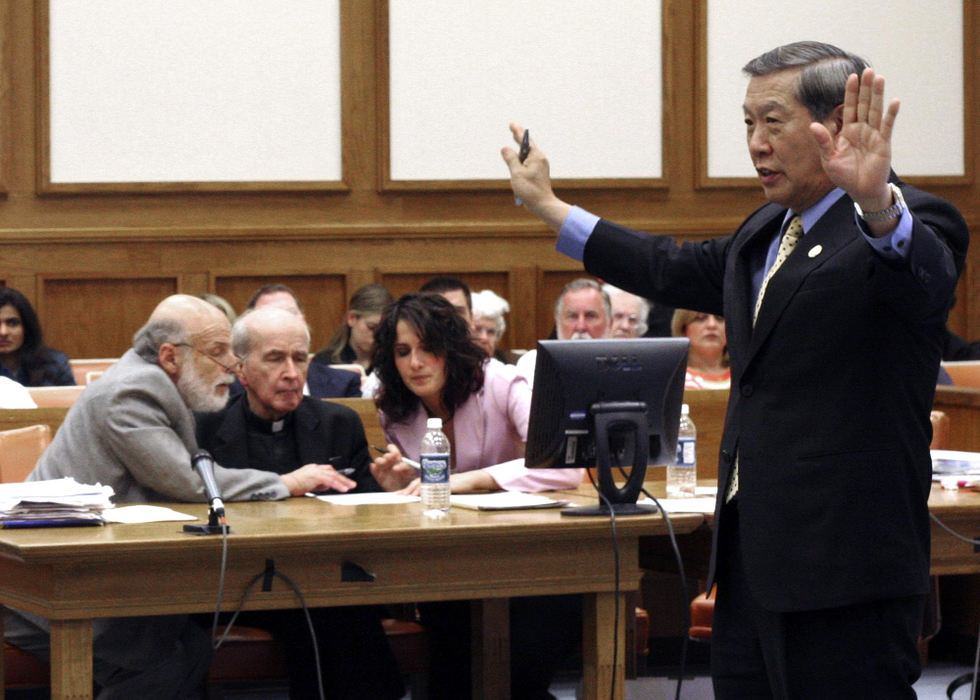 First Place, News Picture Story - Andy Morrison / The BladeThe Rev. Gerald Robinson, centers, confers with attorneys Alan Konopb (left) and Nicole Khoury as Dr. Henry Lee (right) professor of forensics at the University of New Haven, testifies concerning blood spatter and crime scene, April 27, 2006, in Toledo.   