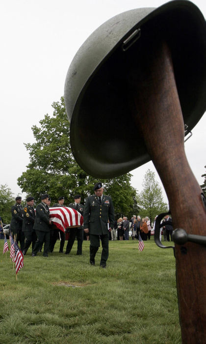 Award of Excellence, News Picture Story - Tim Revell / The Columbus DispatchPallbearers bring the casket of 2nd Lt. Charles "Buddy" Feucht  to his final resting place at Glen Rest Memorial Cemetery.  Feucht was missing action since 1943. His plane along with other members of the crew was discovered in New Guinea in 2002. 