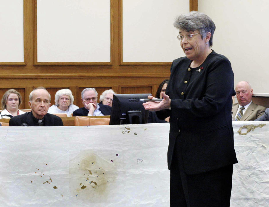 First Place, News Picture Story - Andy Morrison / The BladeBlood stain pattern specialist Paulette D. Sutton, center, a medical examiner with the City of Memphis gives testimony concerning blood stains on the alter cloth in the Rev. Gerald Robinson, right, murder trial, April 26, 2006, in Toledo.   