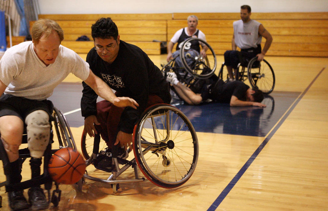 First Place, James R. Gordon Ohio Understanding Award - Lynn Ischay / The Plain DealerThe metal wheels clang together, making the contest sound more like a sword fight than a basketball game. Rod Ramsey and Juan Woidtke fight for a loose ball during the Wheelchair Cavs practice at the Metzenbaum Learning Center in Chester Township. A loud crash behind them barely gets their attention as they battle for possession. “Man overboard!” yells Alan Burgess, the oldest member of the team.	