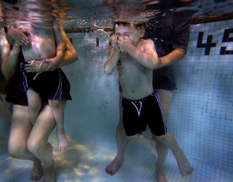 First Place, James R. Gordon Ohio Understanding Award - Dale Omori / The Plain DealerBen Barrick, 3, holds his nose as his mom dunks him underwater. His twin brother, Nate, is next. A moment later, Nicole Barrick lifts Ben to the surface. He blinks the water out of his eyes, ready for whatever’s next during this Tuesday morning parent-toddlers swim class at the West Shore YMCA in Westlake.  “They were a little hesitant at the first class, but by the second they did everything willingly and happily,” said Barrick.	 