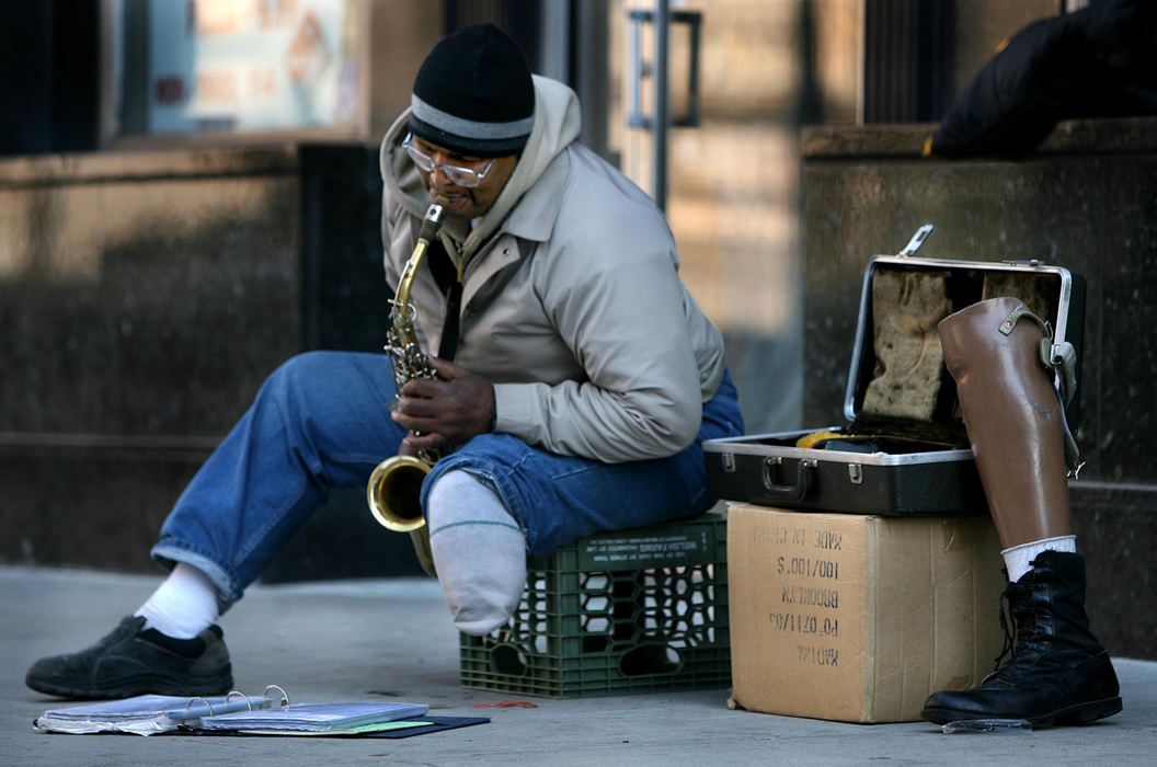 First Place, James R. Gordon Ohio Understanding Award - Dale Omori / The Plain DealerThe chorus from “Eleanor Rigby” bounces off the buildings and sidewalks, then rises above the traffic noise at East Sixth Street and Superior Avenue. It’s the sound of Kelvin Young at work. Young, 57, of Cleveland, also known as Samad Samad, is a self-taught saxophone player. His workplace most days is at this intersection or at the West Side Market. On game days he can be found, depending on the season, outside The Q, Jacobs Field or Cleveland Browns Stadium. His pay is whatever people are willing to toss into his saxophone case.