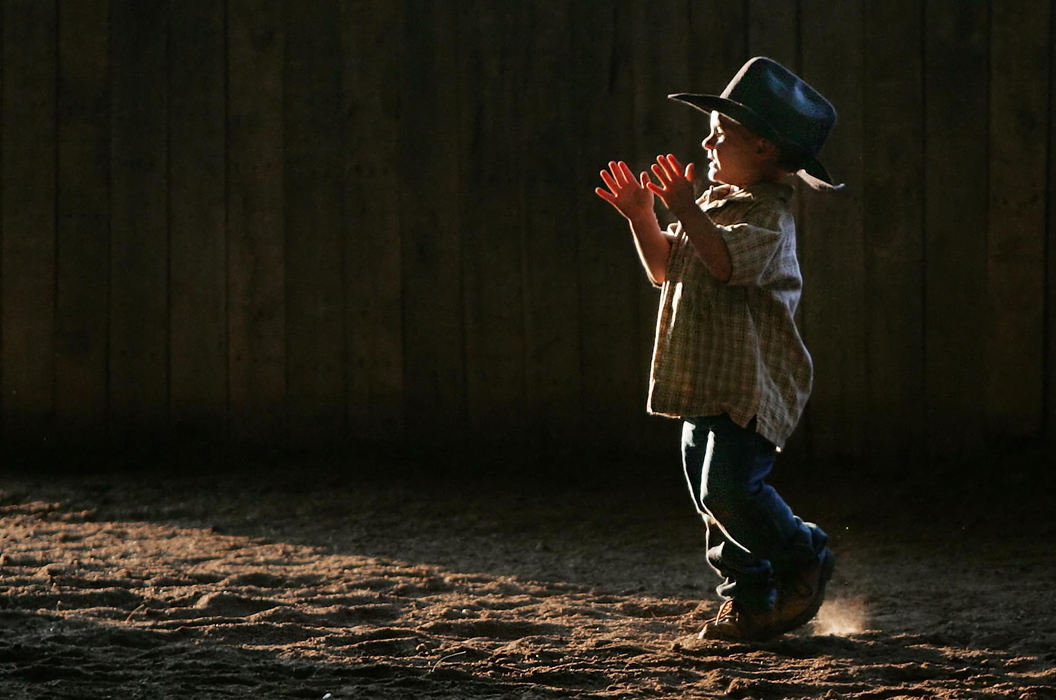 First Place, Photographer of the Year - John Kuntz / The Plain DealerRyan Brucker, 2, of Burton claps as another member of the Life Brand Cowboy Church is baptized by Pastor Royce Gregory in the indoor riding arena at the Twin Pines Stable in Newbury July 19, 2006.  Royce started his ministry May 2 called the Life Brand Cowboy Church geared to folks around the stables who could not attend a Sunday worship service or don't like the conventional church setting.   