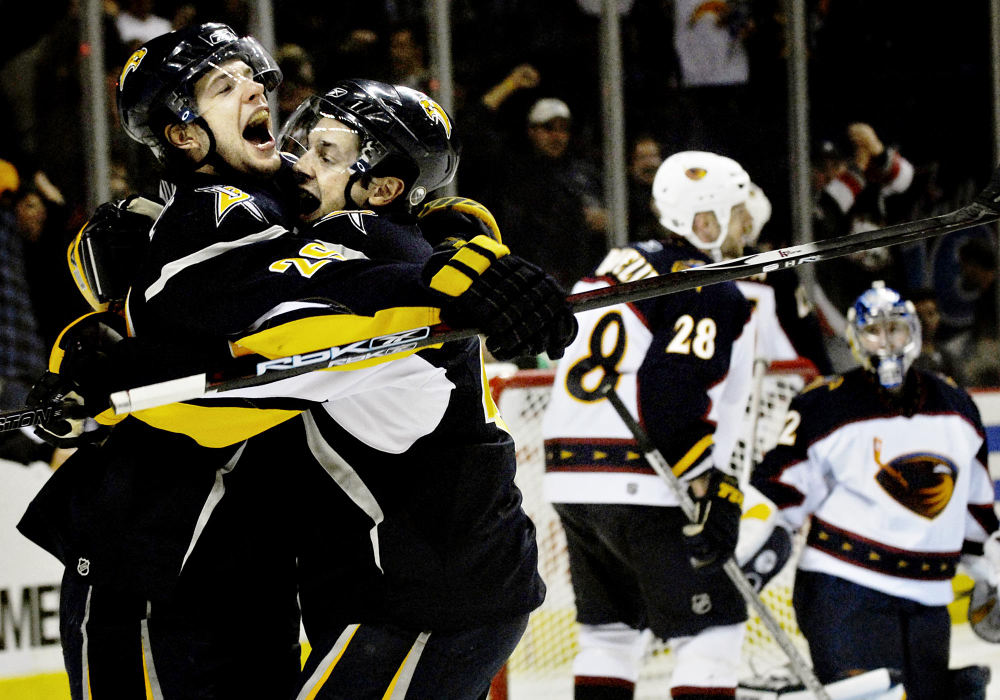 Third Place, Photographer of the Year - Greg Ruffing / FreelanceBuffalo Sabres' Jason Pominville (far left, #29) celebrates with teammate Daniel Briere after scoring a goal late in the third period to tie the game against the Atlanta Thrashers. At right are Atlanta defender Niclas Havelid (#28) and goalie Kari Lehtonen. The Thrashers would go on to win the game in a shootout, 5-4.