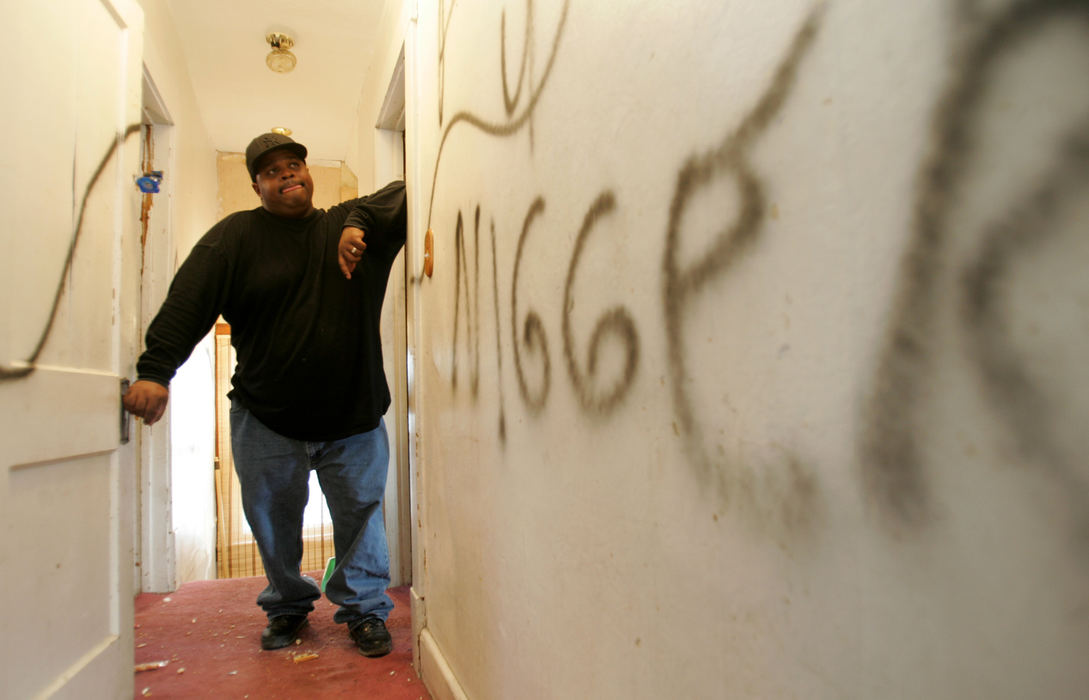 Award of Excellence, Photographer of the Year - Dale Omori / The Plain DealerDion Jones looks at the racial epiteth vandals spray painted on the inside of his Old Brooklyn home Jan. 20, 2006, Cleveland.