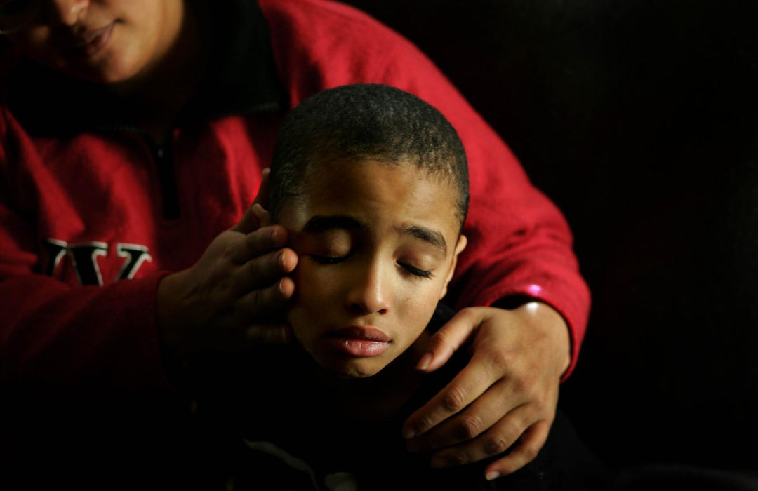Award of Excellence, Photographer of the Year - Dale Omori / The Plain DealerMarie Jackson comforts her son, Darnell, 9, who suffers from sickle cell anemia. Jackson is the mother of five, two of them have sickle cell anemia.  
