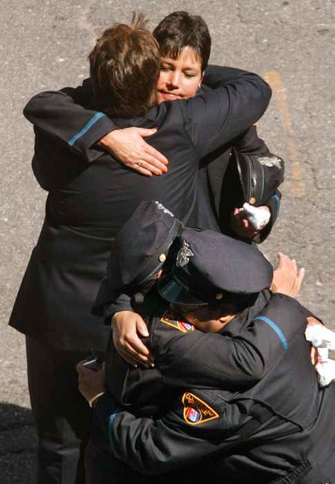 First Place, Photographer of the Year - John Kuntz / The Plain DealerCleveland police officers console one another after the funeral for fellow Cleveland police Detective Jonathan Schroeder at St John Cathedral on East 9th Street in Cleveland September 6, 2006. The 37-year-old detective was fatally shot while serving an arrest warrant.   