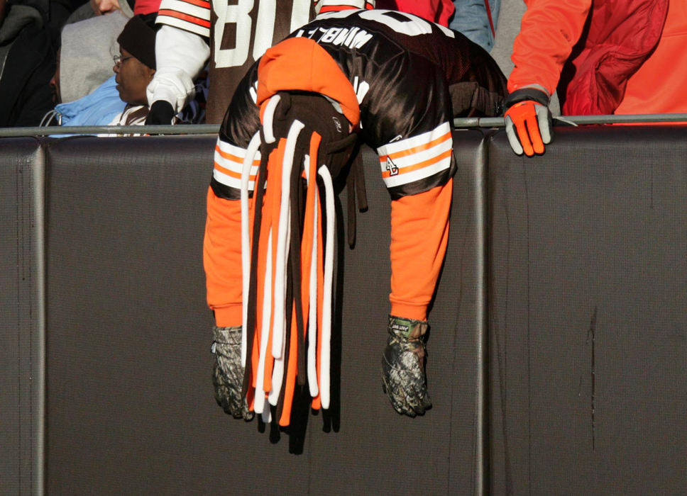 First Place, Photographer of the Year - John Kuntz / The Plain DealerCleveland Browns fan David Dermer of Cortland, Ohio flops over the edge of the wall in the dog pound after Tampa Bay Buccaneers scored a touchdown on an interception in the fourth quarter December 24, 2006 at Cleveland Browns Stadium.  The Bucs won the game 22-7.  