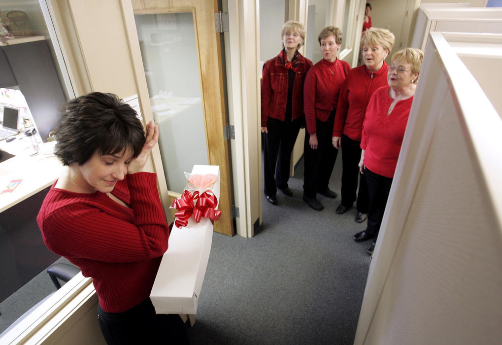 Second Place, Photographer of the Year - Chris Russell / The Columbus Dispatch Amy Bell wipes tears of joy away as members of the Scioto Valley Chorus deliver a surprise Valentine's Day greeting from her boyfriend.  She was standing outside her office at the American Cancer Society and her boyfriend was trying to get himself out of the doghouse.  