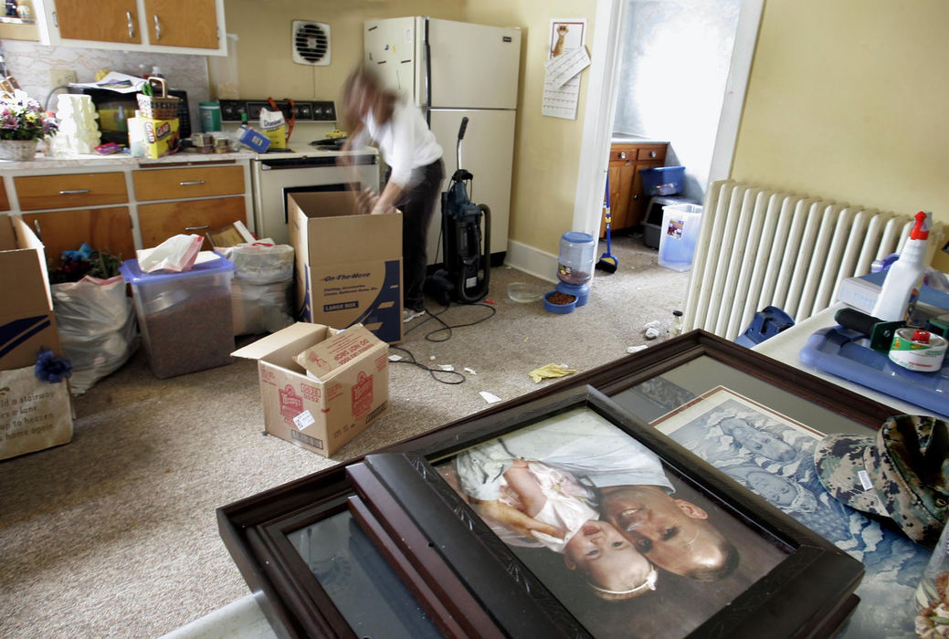 Second Place, Photographer of the Year - Chris Russell / The Columbus DispatchWorking while the older kids are away at school, Lee Ann cleans and packs reminders of her life with Kendall as she prepares to move into a new home made possible by the payments she received for his death.  