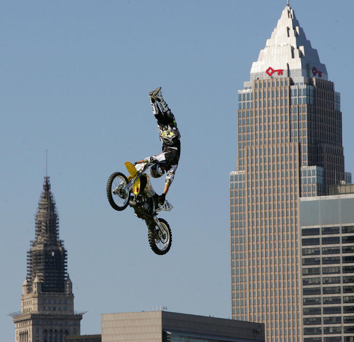 First Place, Photographer of the Year - John Kuntz / The Plain DealerScott Hanlon with FMX East, a touring stunt motocross jumping team, handstands on his seat with the city skyline in the background to the thrill of Grand Prix of Cleveland fans for a little different entertainment between practices and qualifying runs June 24, 2006 at Burke Lakefront Airport. 