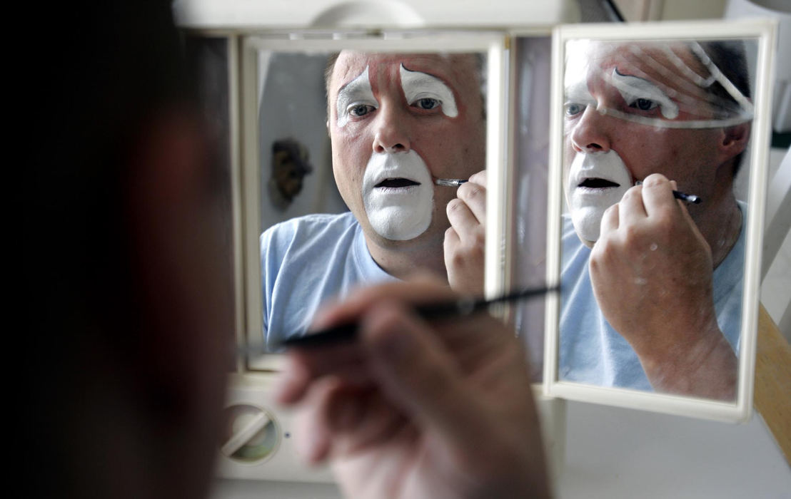 Second Place, Photographer of the Year - Chris Russell / The Columbus DispatchMatthew begins a one hour process to apply his clown makeup at home before heading out for his first job as a clown since returning from serving in Iraq. 