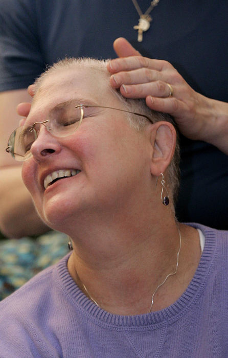 Second Place, Photographer of the Year - Chris Russell / The Columbus DispatchAudrey is all smiles as Lee rubs lotion on her newly shaved head after an elaborate ceremony in their living room to shave her head.  