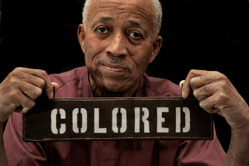 Second Place, Photographer of the Year - Chris Russell / The Columbus DispatchOtis Henderson , 78, displays a grim reminder of Jim Crow days.  Henderson, a college classmate of Martin Luther King Jr.'s took the sign from a bus he rode to Fort Benning, Ga., when he was drafted during WW  II. 