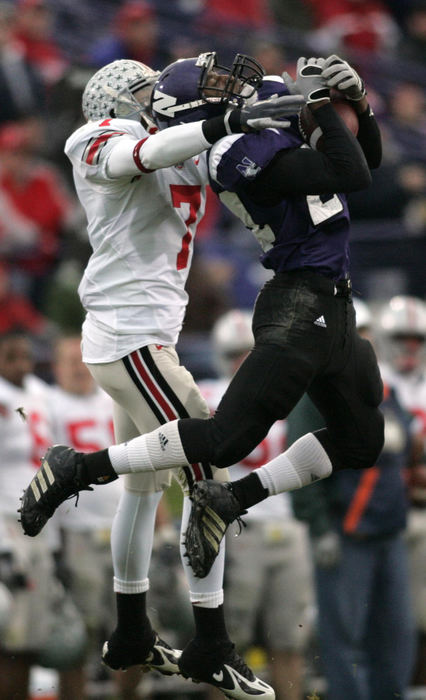 Second Place, Photographer of the Year - Chris Russell / The Columbus DispatchOhio State wide receiver Ted Ginn Jr. tries to break up an interception by Northwestern's Sherrick McManis in the first half of their game at Ryan Field.  