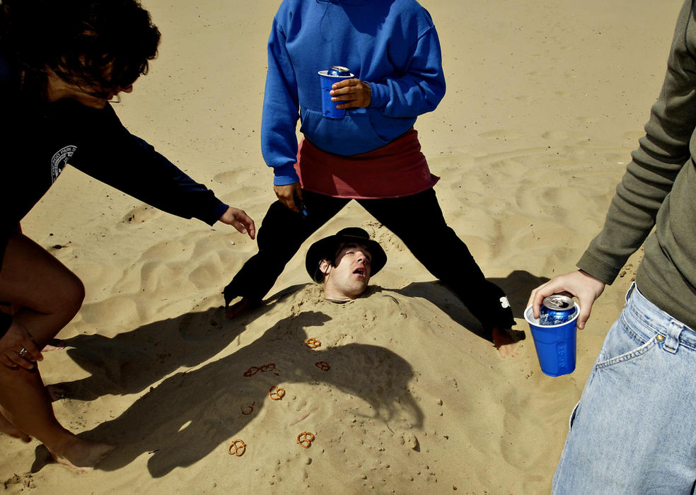 Third Place, Photographer of the Year - Greg Ruffing / FreelanceA group of college students bury a friend in the sand while partying along the shores of Lake Michigan in Chicago to celebrate the end of their semester.