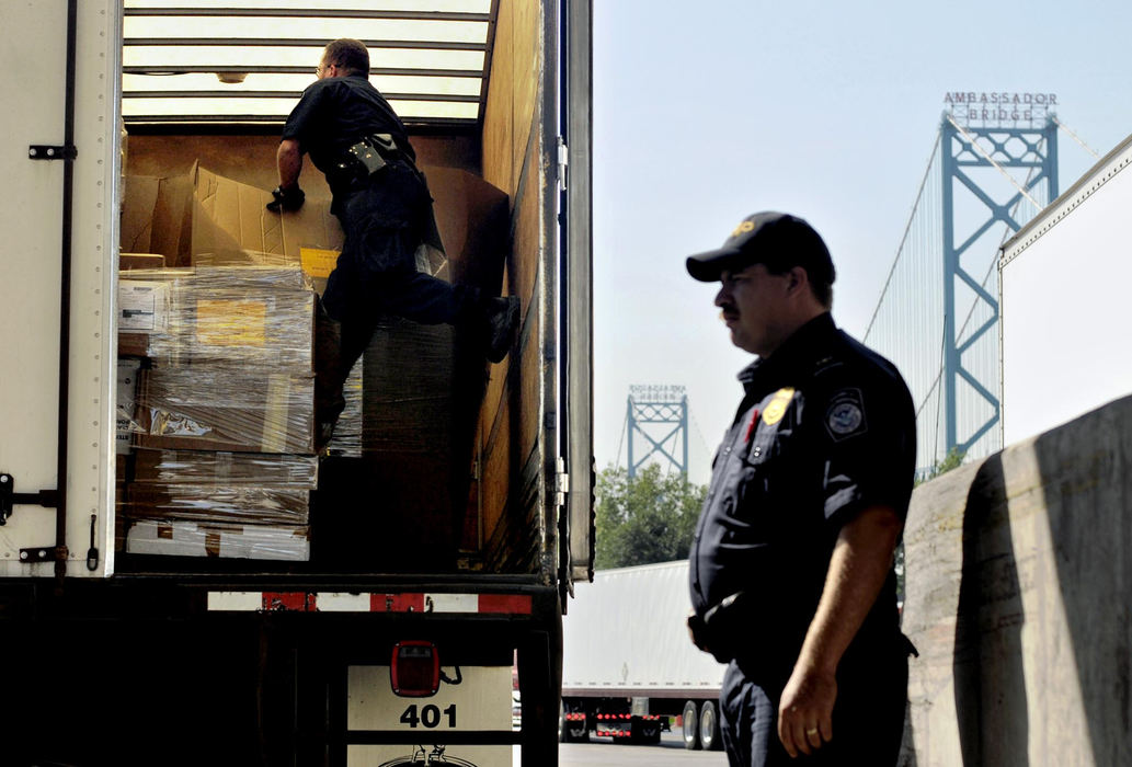Third Place, Photographer of the Year - Greg Ruffing / FreelanceU.S. Customs and Border Protection officers inspect the cargo in a tractor trailer truck at the Ambassador Bridge port of entry from Windsor, Ontario, Canada, into Detroit. More than 6,000 commercial vehicles cross the border at the Ambassador Bridge every day, according to CBP spokesman Ron Smith. 