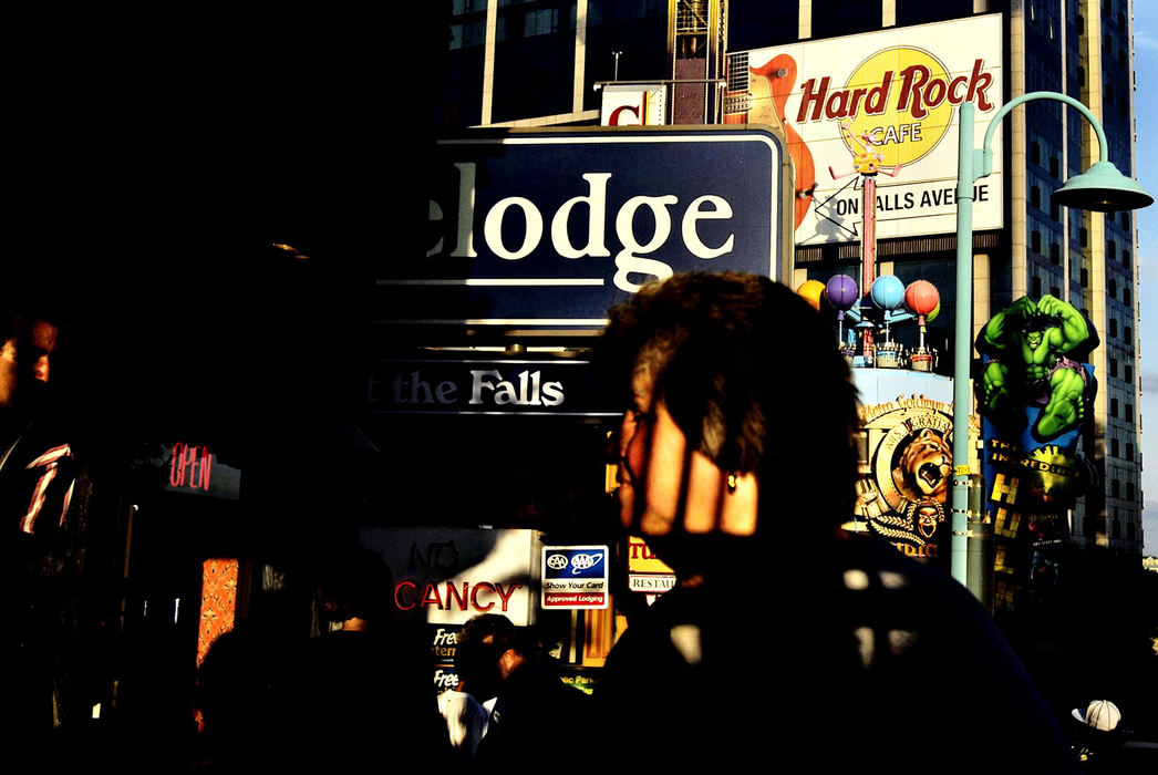 Third Place, Photographer of the Year - Greg Ruffing / FreelanceA street scene on Clifton Hill, the main drag of shops, arcades, museums and restaurants in Niagara Falls, Ontario, Canada. As security along the U.S.-Canada border has been beefed up after 9/11, many people on both sides of the border, especially business leaders, have been concerned about keeping the border open enough to facilitate commerce and tourism between the two countries. 