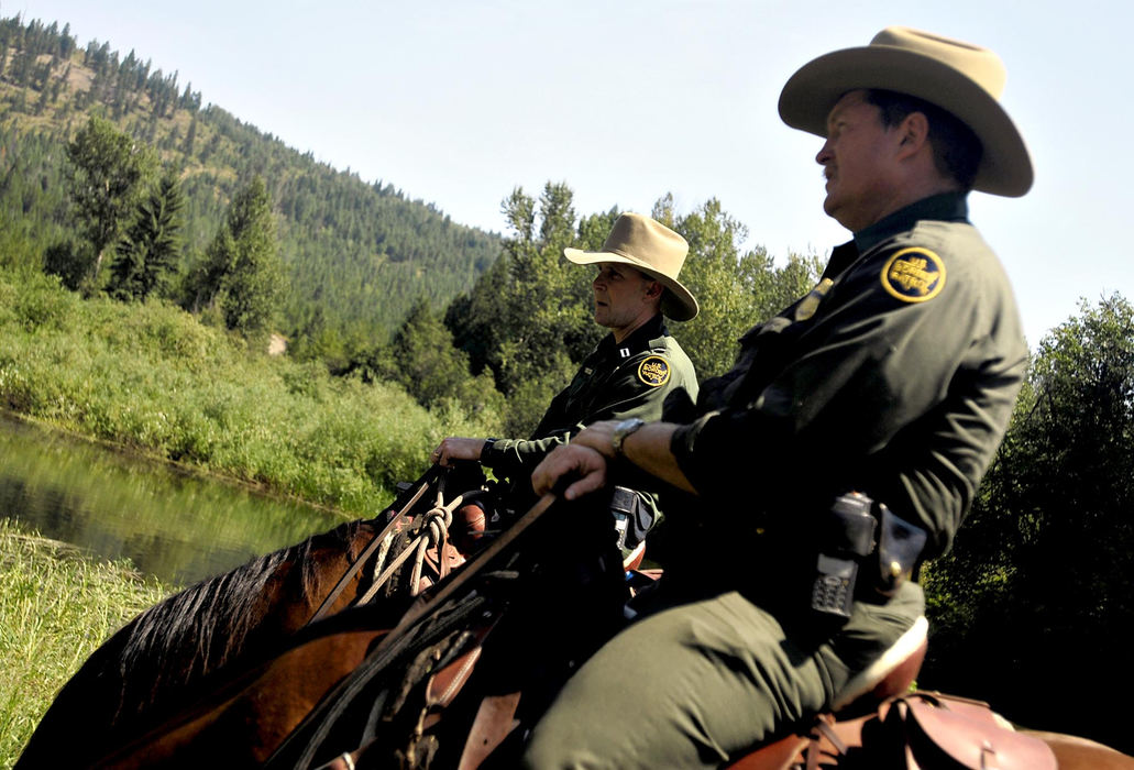 Third Place, Photographer of the Year - Greg Ruffing / FreelanceU.S. Border Patrol agents Allen Foraker (right), a senior patrol agent, and Gary Roman, a supervisory border patrol agent, patrolling on horseback among rugged mountain terrain along the U.S.-Canada border near Colville, Washington. The agents operate out of the Spokane, Washington sector, which is the first sector on the U.S.-Canada border to use horseback patrol. The horses allow the agents more mobility and efficiency on the tough landscape.
