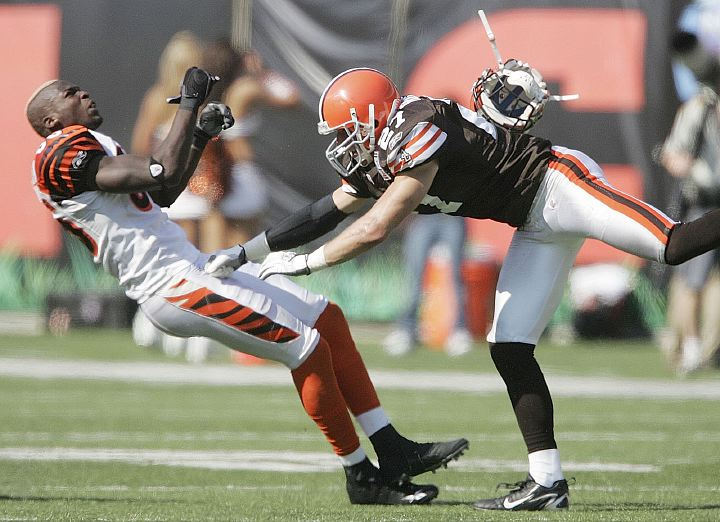 Third Place, Sports Action - Neal C. Lauron / The Columbus DispatchCincinnati Bengal's Chad Johnson, 85, takes a hit by Brown's Brian Russell, 27, as Johnson went for a pass in the second half of their game at  Paul Brown Stadium, September 17, 2006.