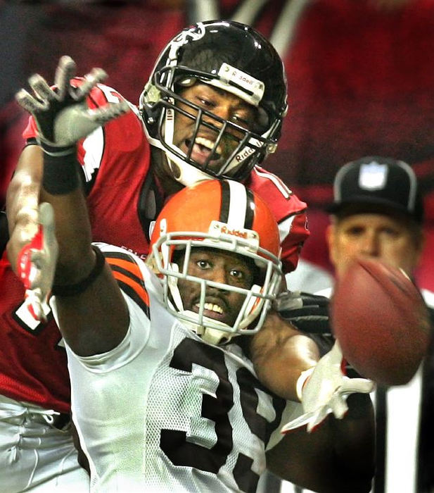 Award of Excellence, Sports Action - Chuck Crow / The Plain DealerThe eyes of Cleveland Browns defensive back Daven Holly and Atlanta Falcons receiver Michael Jenkins have the football in their sights, but the hands to not. Holly busted up this pass in the 4th quarter. This made Atlanta settle for a field goal and the Browns held on to win the game 17-13.