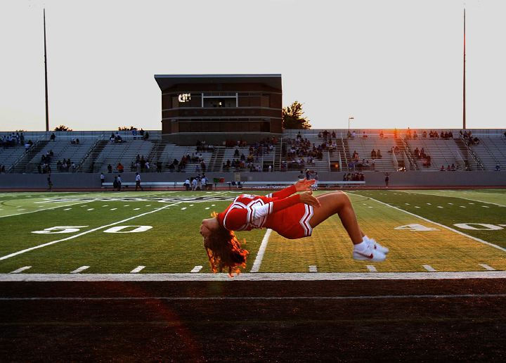 Award of Excellence, Sports Feature - Thomas Ondrey / The Plain DealerParma High School cheerleader Jacklyn Anderson can't really levitate. She's flipping down the sidelines in warm-up for the first football game of the season. Anderson's prior experience as a gymnast helped her qualify for the varsity squad. 