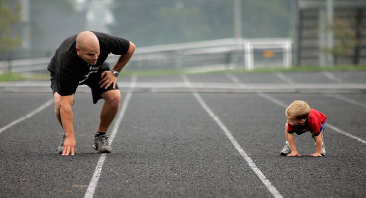 Third Place, Sports Feature - Jeff Hinckley / The Columbus DispatchWesterville High School football coach Justin Montgomery (left) sets to run sprints with his son Mason, 2, while waiting for the team to come out for practice.  