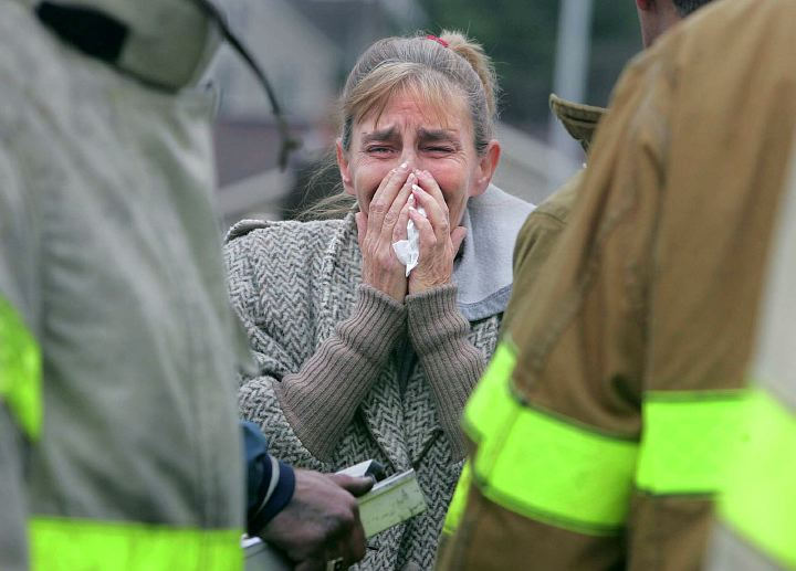 Award of Excellence, Spot News over 100,000 - Phil Masturzo / Akron Beacon JournalDiane Messenger is overcome at the site of a fatal fire on  Dec. 28, 2006, on Second Street Southwest in Canton. Her cousin Tommy Moyer and four others died in the early-morning fire. 