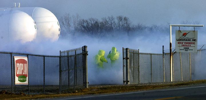 Second Place, Spot News under 100,000 - Marshall Gorby / Springfield News-SunMembers of the Clark County Hazardous Material team enter a vaporous cloud caused by anhydrous ammonia leaking from a 30,000 gallon tank at Southwest Landmark Inc. in South Charleston. The Haz-Mat team had to work through the cloud to shut off a valve to stop the dangerous chemical leak.