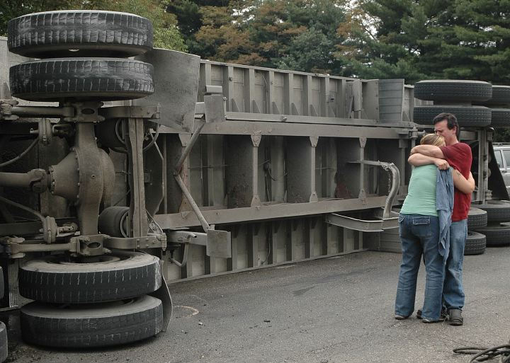 Award of Excellence, Spot News under 100,000 - Aaron Rudolph / Lisbon Morning JournalTruck driver William Edwards is consoled after his rig spilled its load of coal.