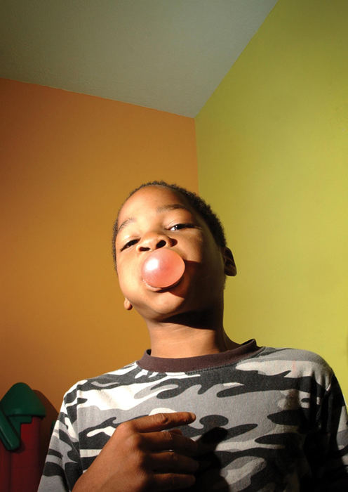 First Place, Student Photographer of the Year - David Foster / Kent State UniversityJermey Blue, 8, blows a bubble in the playroom of the Miller House, a half way house for individuals and small families, in Kent.