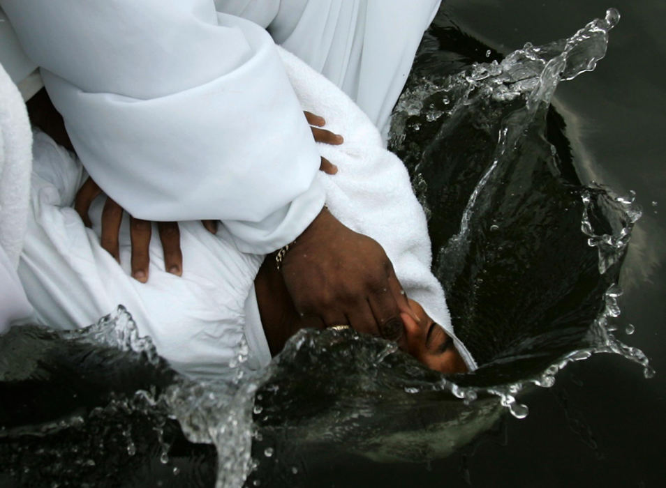 First Place, Student Photographer of the Year - David Foster / Kent State UniversityGio Ingersol, 14, has his body dunked and baptized by Rev. Melford Elliott and Minister Terry Beasley in Lake Anna in Barberton. 