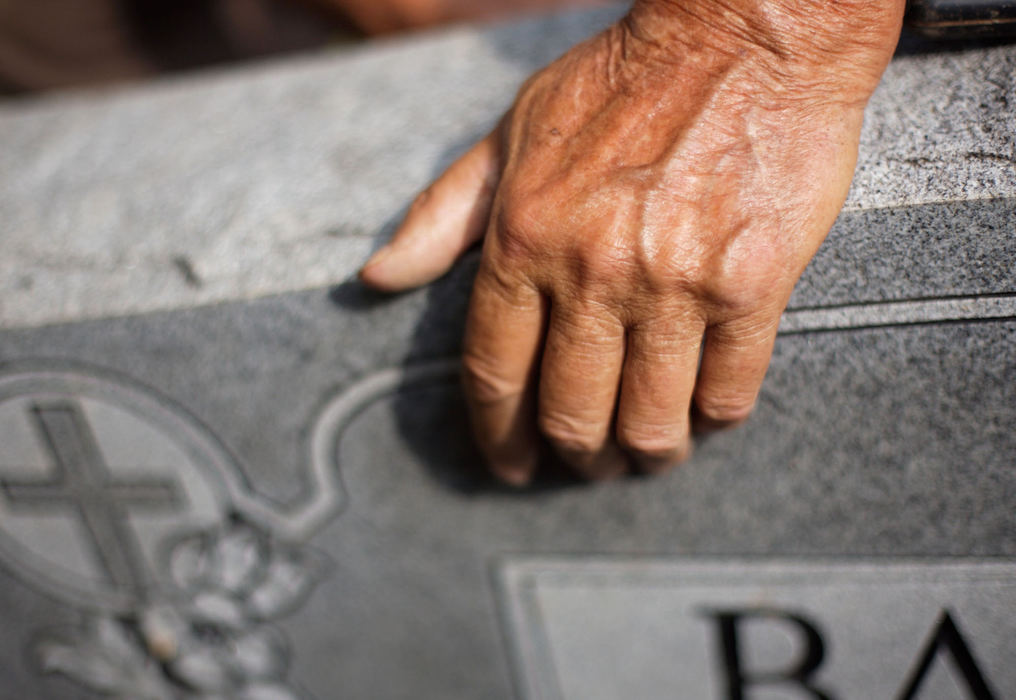 Second Place, Student Photographer of the Year - Michael P. King / Ohio UniversityBibbee rests his weathered hands on a gravestone at Fairview Cemetery, north of Coolville, while digging on Oct. 3, 2006.