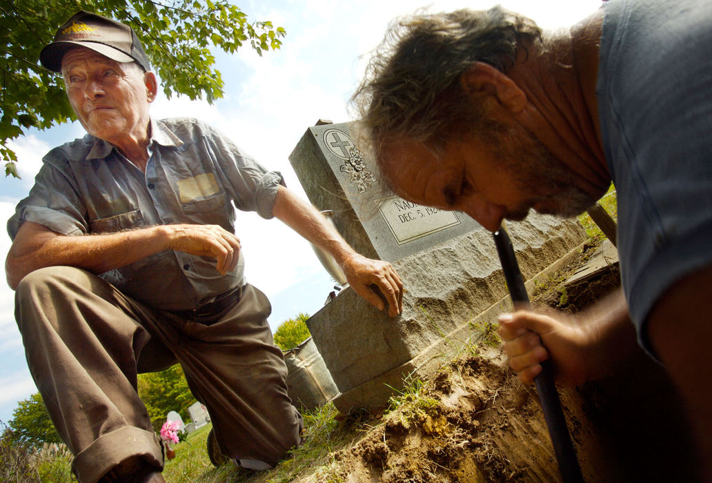 Second Place, Student Photographer of the Year - Michael P. King / Ohio UniversityBibbee, unable to break through bedrock at the bottom of a new grave, oversees help from Delbert Smith (right) at Fairview Cemetery, north of Coolville, Oct. 3, 2006.