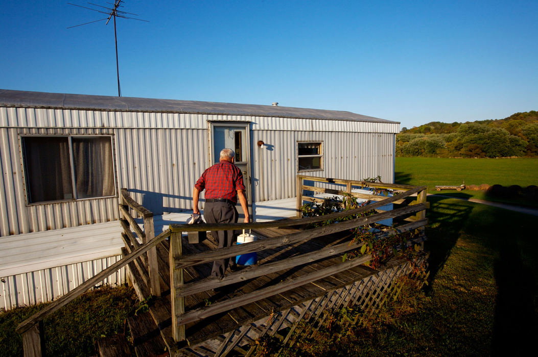 Second Place, Student Photographer of the Year - Michael P. King / Ohio UniversityBibbee enters his trailer home near Coolville, Oct. 1, 2006. Because of the absence of running water in the trailer, Bibbee carries jugs of water home from his friend Helen Findling's house on a daily basis.