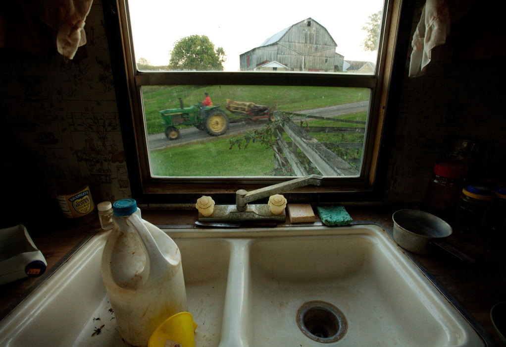 Second Place, Student Photographer of the Year - Michael P. King / Ohio UniversityBibbee leases the land his trailer home sits on from a farm near Coolville. Shown is the inactive faucet and the bottle Bibbee urinates into in his kitchen, Oct. 1, 2006.