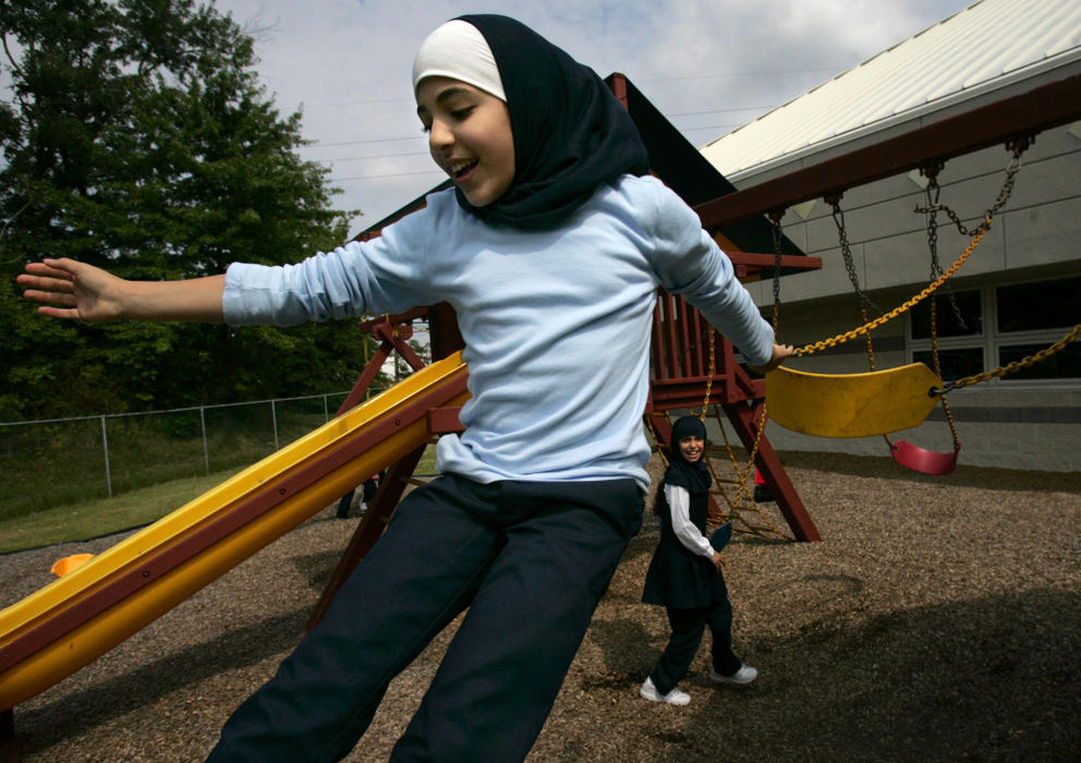 First Place, Student Photographer of the Year - David Foster / Kent State UniversityTwo girls play on the swingset during recess at the Islamic Community Center in Cuyahoga Falls.