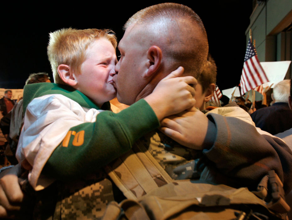 Second Place, Student Photographer of the Year - Michael P. King / Ohio UniversityStaff Sgt. Scott Dickson of Cambridge, Wis., kisses his son Kyzer, 6 (left) after returning from Iraq with fellow soldiers of the Wisconsin Army National Guard’s 2nd Battalion, 127th Infantry, at Volk Field, Wis., Aug. 17, 2006. Approximately 300 soldiers from the unit were reunited with their families after about one year of duty in Iraq.