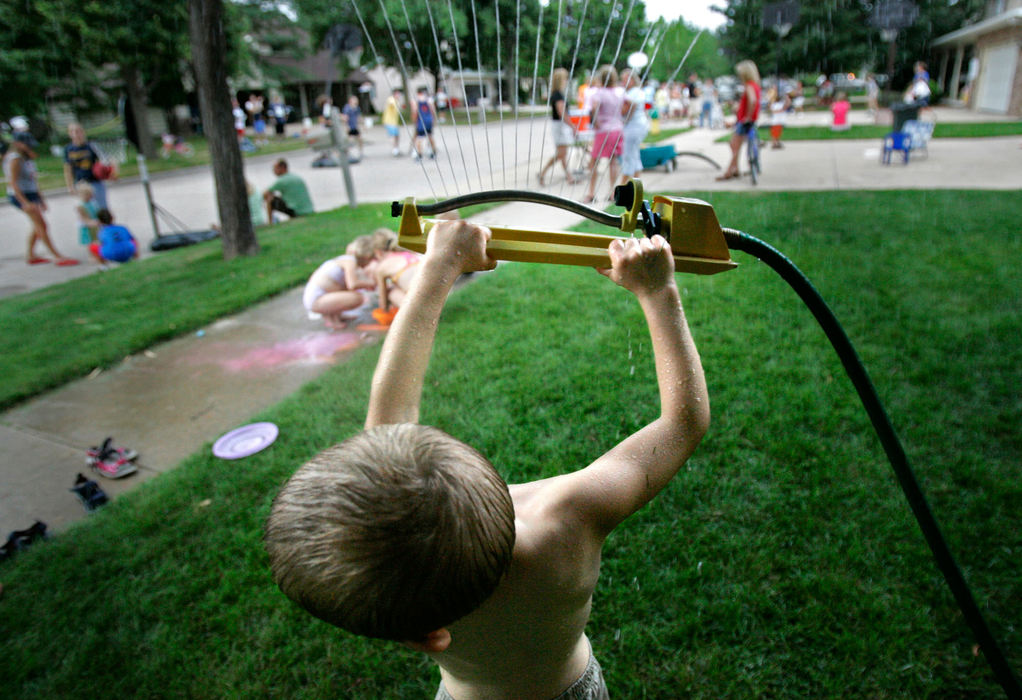 Second Place, Student Photographer of the Year - Michael P. King / Ohio UniversityNathan Gebert, 6, hoists over his head the lawn sprinkler he and his friends were playing in at a neighborhood gathering on South Clara Street as part of National Night Out in Appleton, Wis., on August 1, 2006.